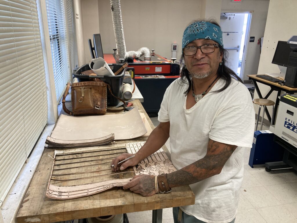 A man cutting leather.